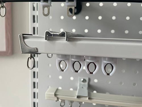 A collection of curtain track profiles made from aluminum, plastic, and steel