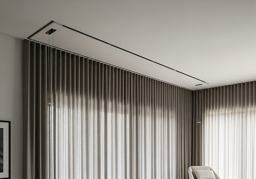 A sleek, minimalist living room with invisible curtain tracks and floor-to-ceiling drapes