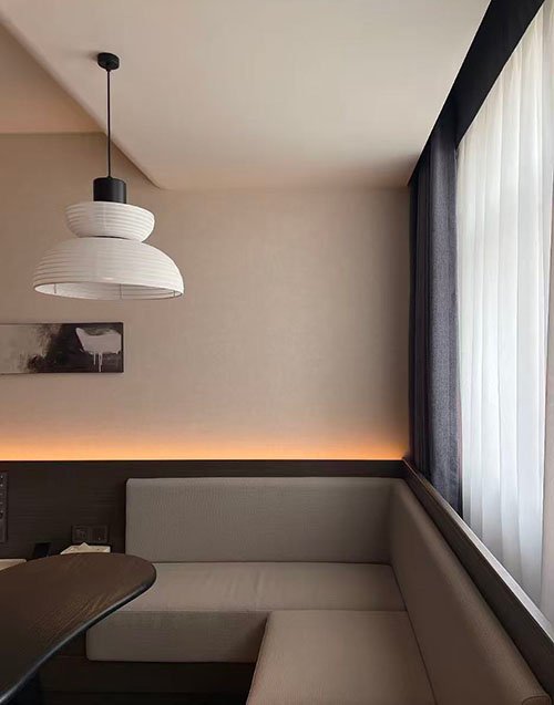 A standard, slim profile curtain track slightly bending under the weight of a medium curtain