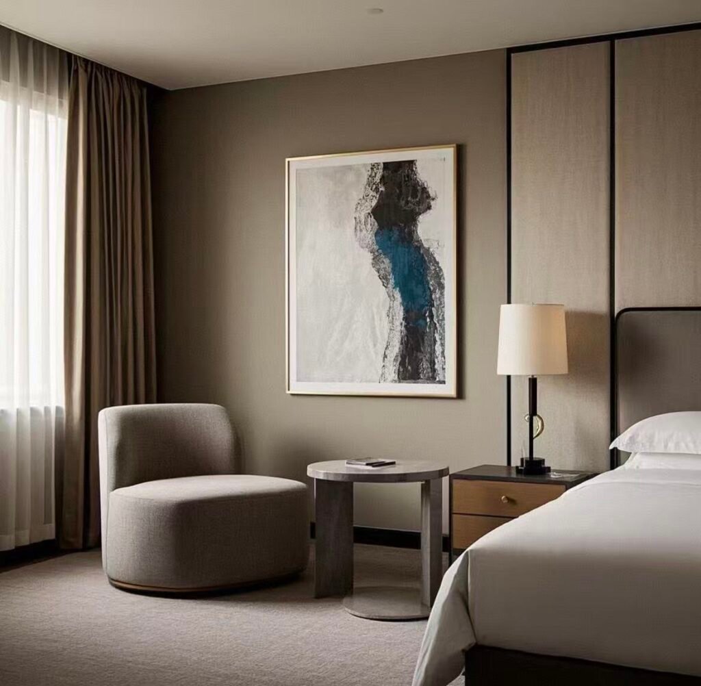 A hotel room window with one track holding a sheer curtain and a second track behind it with a blackout curtain