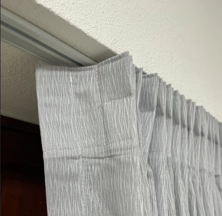 Heavy-Duty Blackout Curtain Track A close-up view of a heavy-duty hotel curtain track with smooth-running carriers.