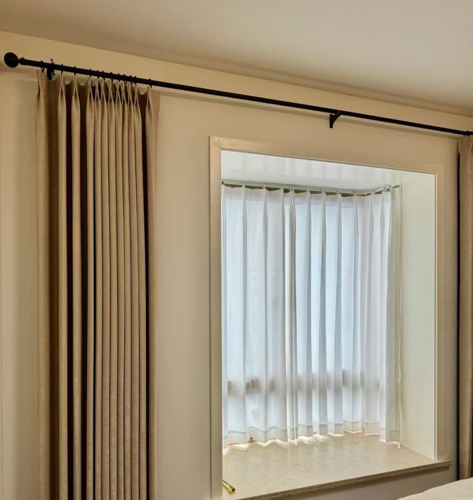 A sleek, ceiling-recessed curtain track in a modern hotel room, creating a clean look