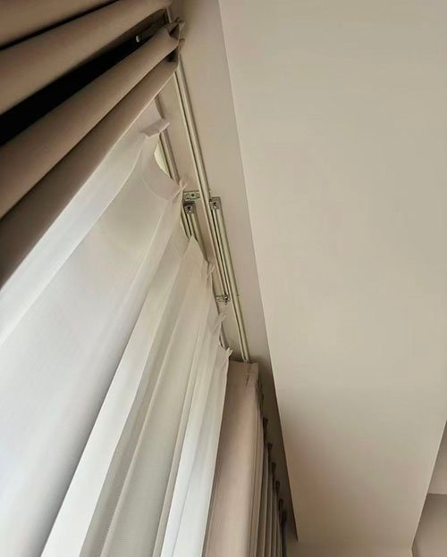A ceiling-recessed curtain track creating a floating curtain effect