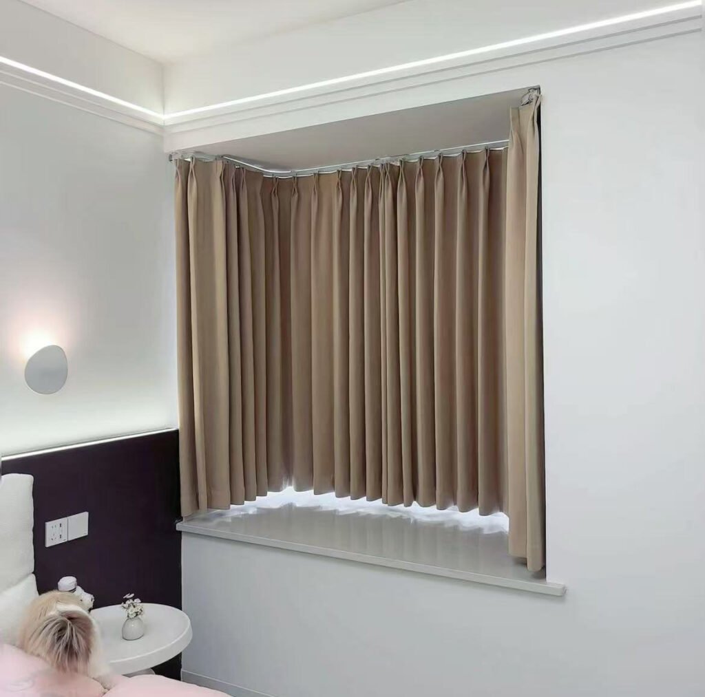 A motorized curved curtain track operating smoothly in a luxury hotel room with a curved glass wall