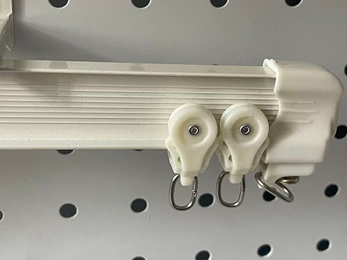A pristine aluminum curtain track installation in a modern, busy hotel lobby